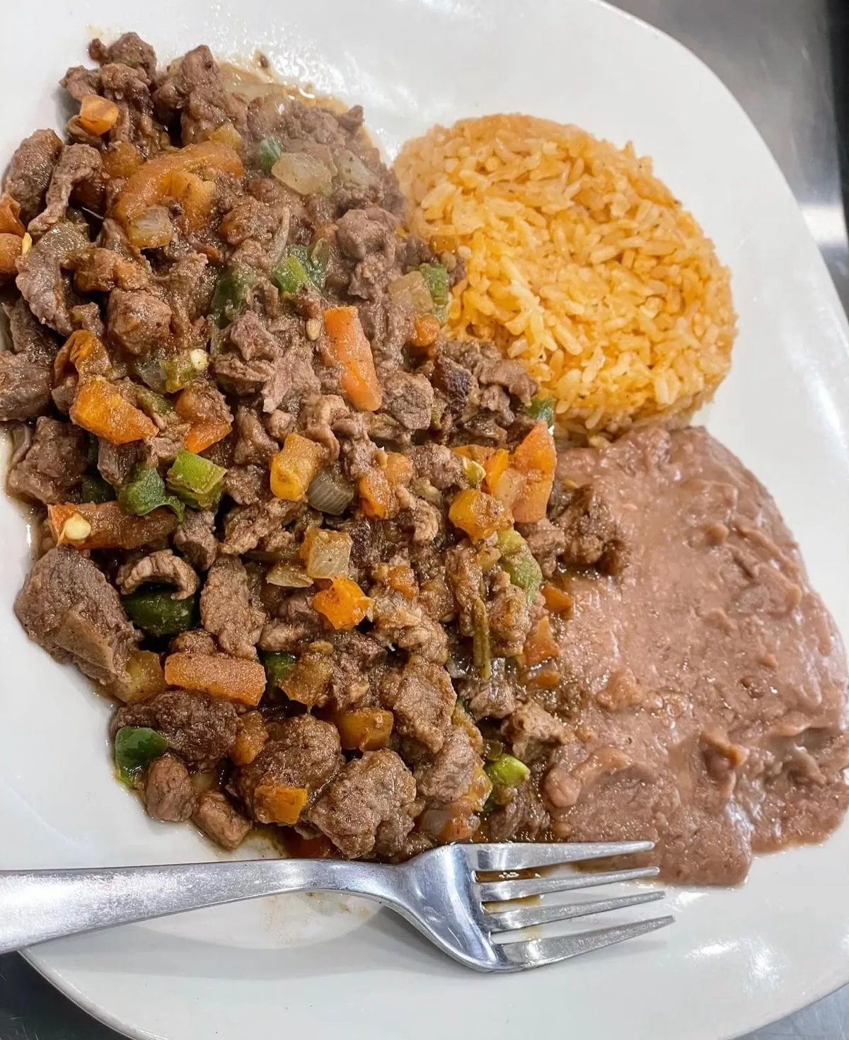 Bistec ranchero plate with diced beef in ranchero salsa, rice and beans from Loredo's Tortilleria