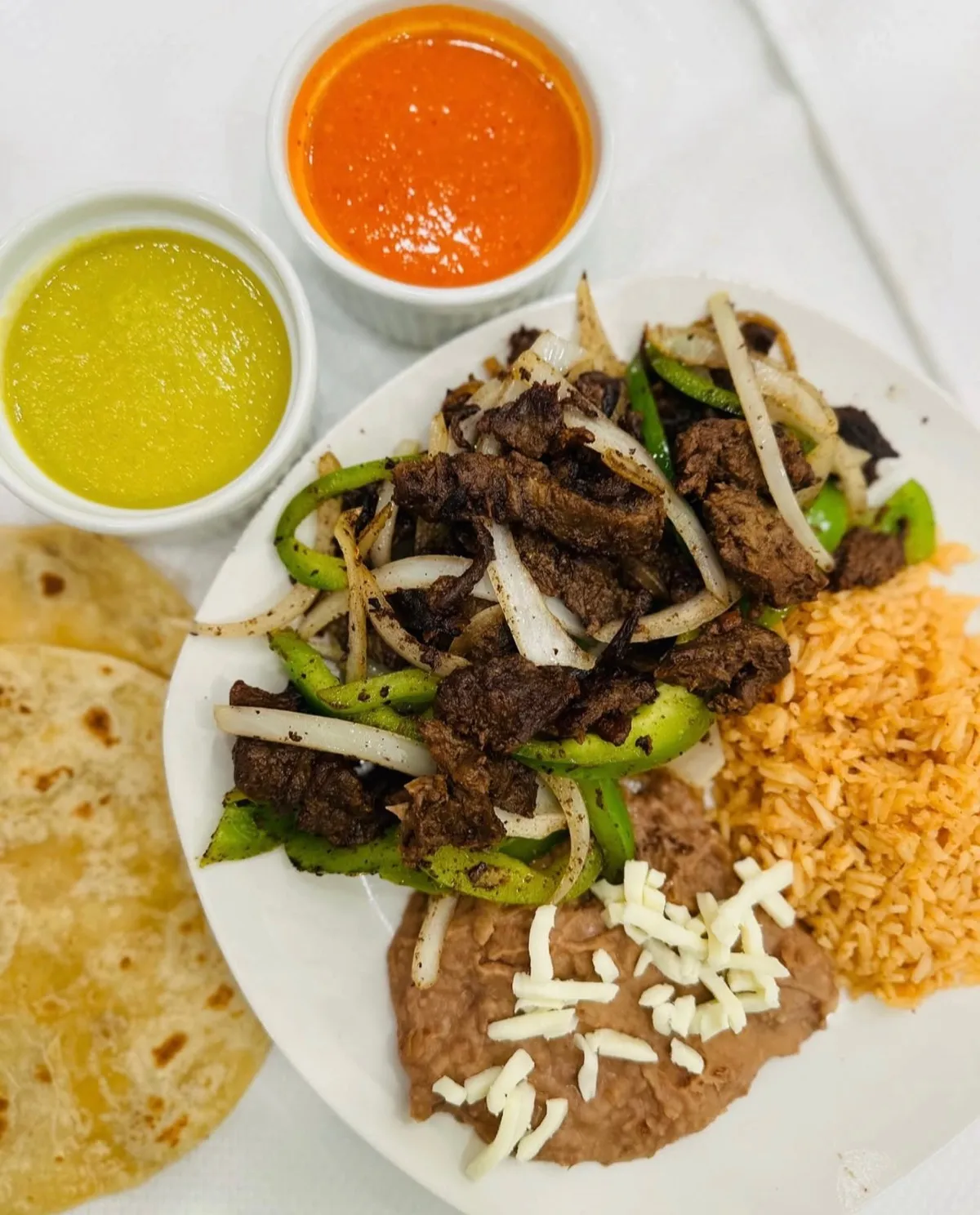 Beef fajita plate with bell pepper, onion, rice and beans from Loredo's Tortilleria