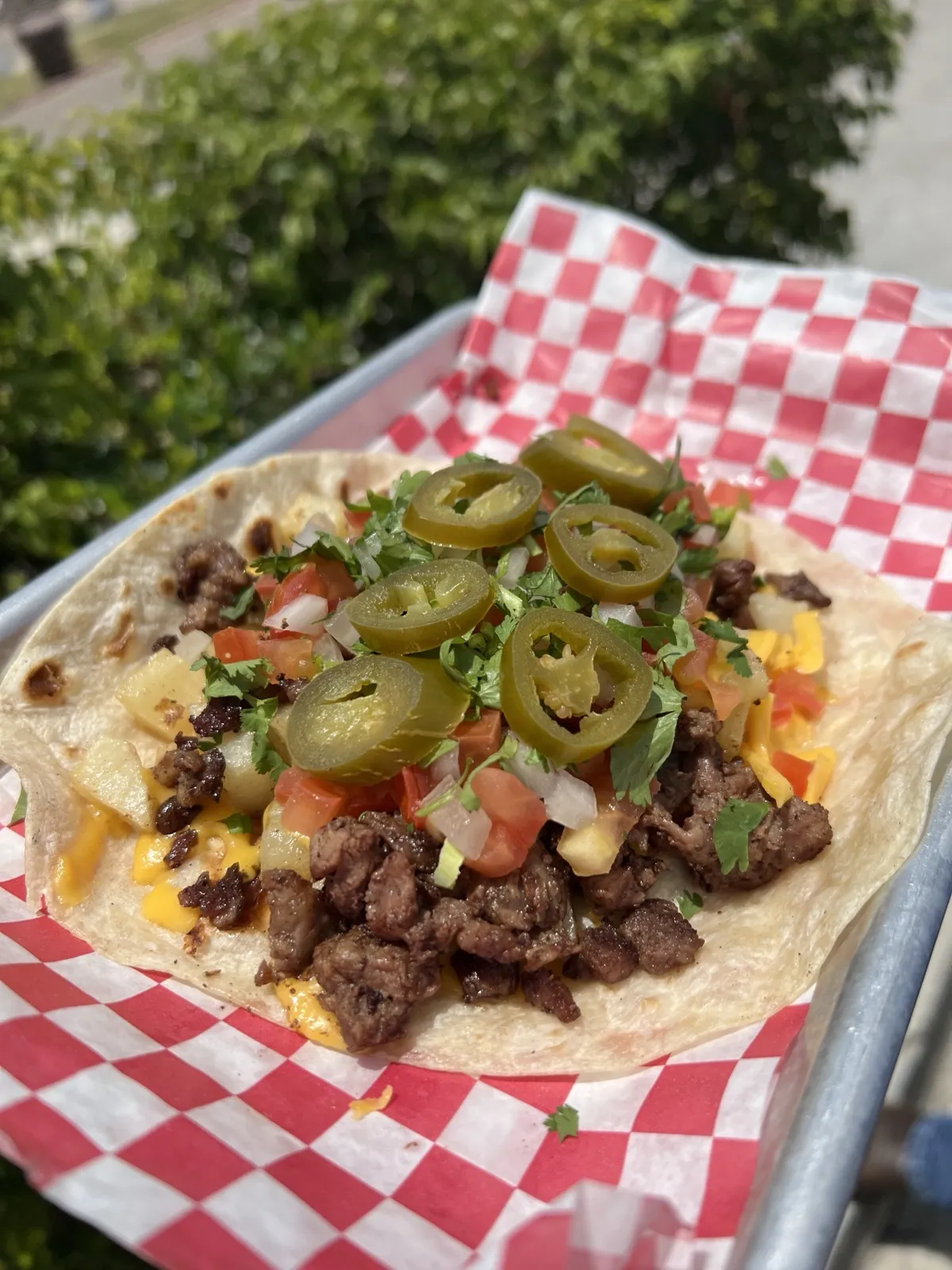 The King Taco with diced potatoes, chopped steak, pico de gallo and cheese from Loredo's Tortilleria